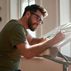 man drafting at desk